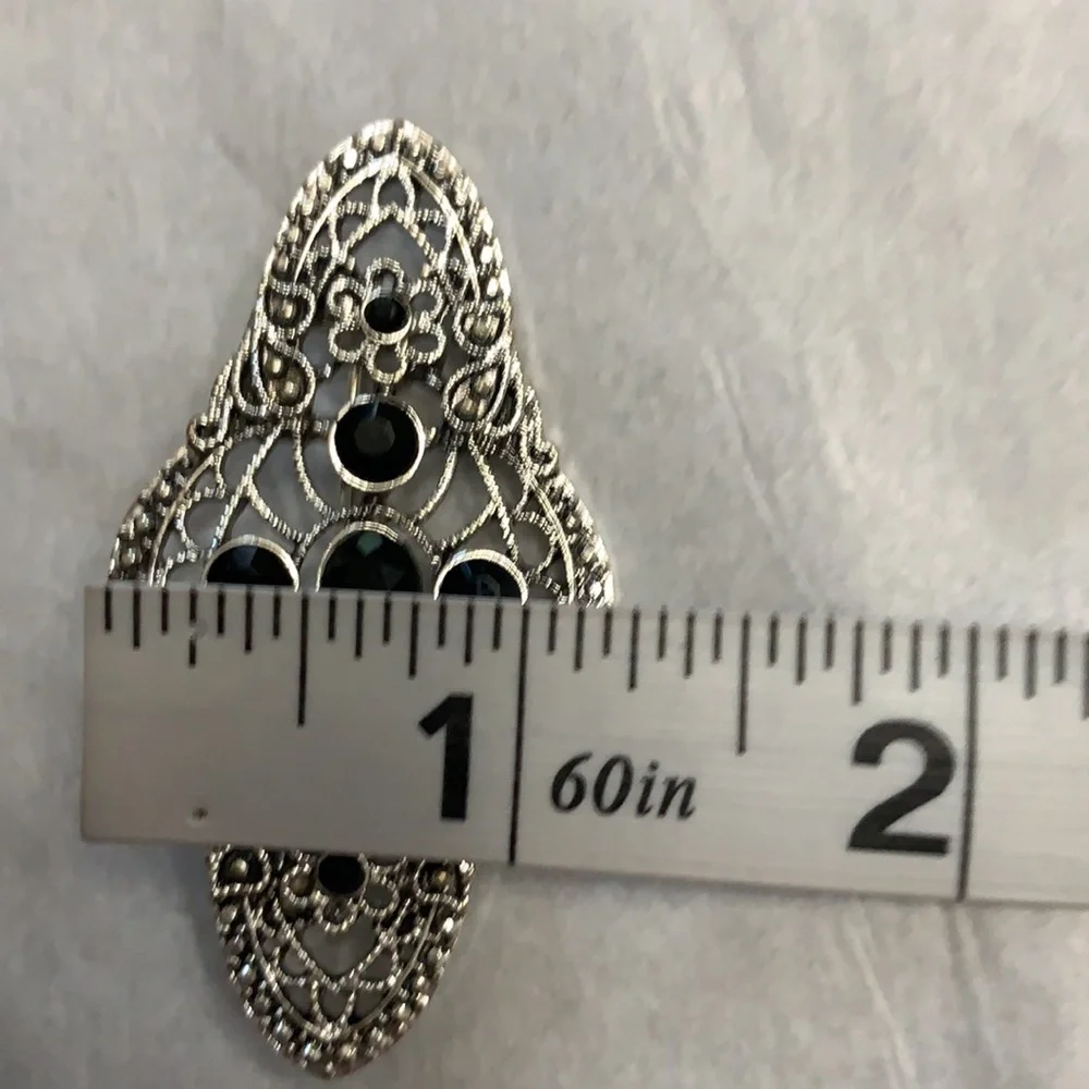 Silver and black brooch